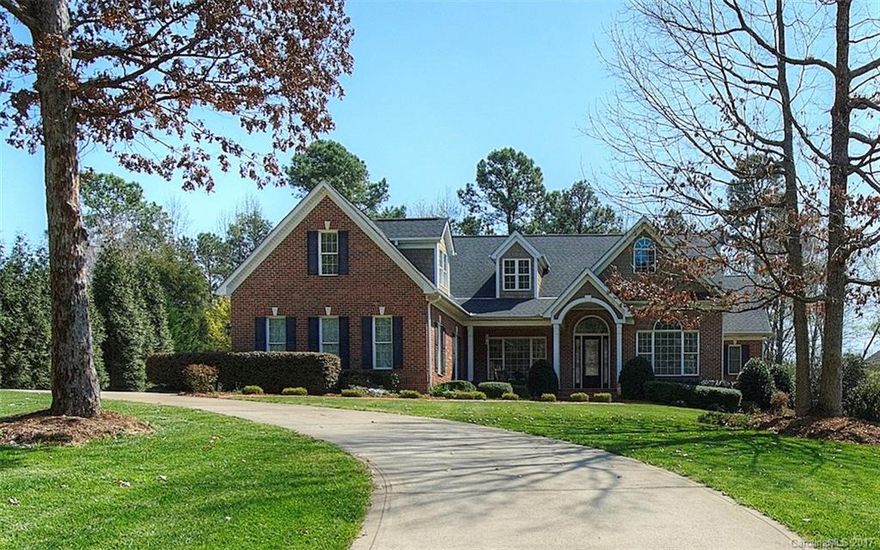 Executive waterfront home in Misty Waters, Belmont's premier gated community! Launch a canoe from your backyard, or walk to the n'hood marina to take your boat out on Lake Wylie. Home is designed to enjoy the outdoors, with expansive deck, shady pergola, relaxing hot tub, and firepit. Cook's kitchen has gorgeous custom cabinetry, a breakfast area and cozy hearth room.  Master suite & office on main level, featuring exotic hardwood floors sure to impress. Formal dining, media room & flex space!