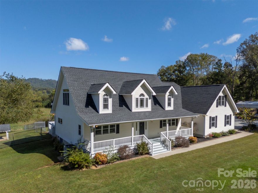 This spacious 3,529 sq ft home is centrally located between Hendersonville and Asheville, offering year-round mountain views from a private 4-acre lot. The home features an open floor plan with soaring ceilings, large windows, and skylights that fill the space with natural light and maximize the stunning views. The well-appointed kitchen includes stainless steel appliances, a breakfast bar, hickory cabinets, and a large walk-in pantry. The kitchen flows seamlessly into the dining area, which boasts a thermostatically controlled gas fireplace, and is open to the living area and rear deck—perfect for family gatherings and entertaining. Recent updates include new vinyl plank flooring and new carpeting in the bonus room. The primary suite offers a tranquil retreat with double walk in closets, an en-suite bathroom with jet tub and walk in shower.  Additionally, there is a large main level bedroom and a third bedroom located upstairs. A huge bonus room above the garage, with separate entry stairs, provides an ideal spot for a game room or private living area. Additional features include an oversized two-car attached garage, a separate storage building, and a metal carport. City water and natural gas is also available, as per seller.