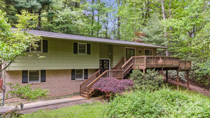 Enjoy the best of both worlds - privacy and convenience! This bi-level home is tucked away in the woods at the end of a cul-de-sac surrounded by nature, yet less than 10 minutes to downtown Hendersonville. It's also roughly 30 minutes to waterfalls and hiking in Dupont State Forest. Drink your morning coffee on your secluded front deck listening to the birds and the creek, or cozy up inside by the fireplace. The main level features hardwood floors, a spacious living room, newer kitchen, three bedrooms and two full baths. In the lower level you have an additional full bath, and plenty of space for a rec room, home gym, storage, den, etc. Bring your creative touches and make this home your own!