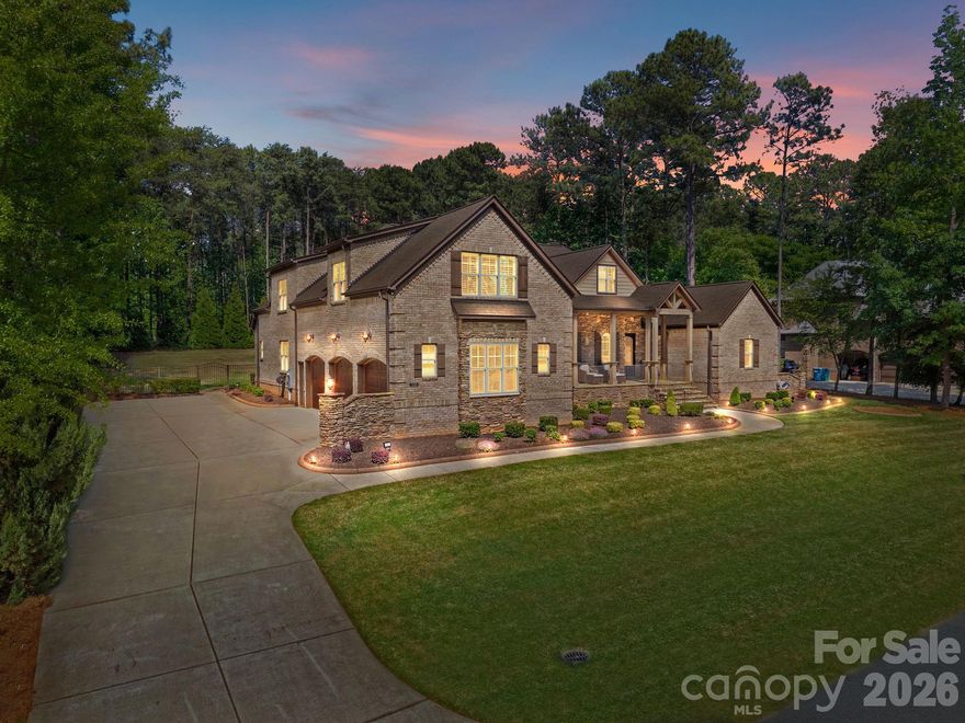 Welcome home to this stunning all-brick residence nestled on a picturesque street with views of Lake Norman. Designed for both entertaining and multi-generational living, this home features a 3-car garage with epoxy floors and custom storage, and ample parking. Inside, the open-concept floor plan seamlessly blends comfortable living with effortless entertaining. The thoughtfully designed layout offers privacy and space for everyone, including a huge bonus room and a dedicated home theater, creating the perfect setting for both everyday living and memorable gatherings. The spacious owner’s suite provides direct patio access, a luxurious ensuite bath complete with a heated towel rack, and an impressive walk-in closet featuring a granite island dresser. Step outside to an extraordinary outdoor living space that truly sets this home apart. The covered area showcases stamped concrete, vaulted open-truss ceilings, surround sound, and a stunning stone fireplace with built-in firewood storage. The outdoor kitchen and bar are designed to impress, offering seating for 10+ guests (10 bar stools convey), a gas grill, gas fire table, bar sink, beverage refrigerator, recessed ice bucket, and ample storage with custom cabinets and drawers. In addition, a separate circular stone fire pit with built-in seating creates another inviting gathering space, complemented by comfortable outdoor furniture that conveys with the home. The 5 seater, coffee table and 2 rocking chairs to the left also convey. The fully fenced backyard enhances both privacy and functionality, making it ideal for entertaining or relaxing. Additional upgrades include a central vacuum system, whole-home water filtration system, and water softener, adding both convenience and quality to everyday living. Residents also enjoy access to the community pool, along with a nearby golf club offering optional memberships for those seeking country club amenities. Attached is a list of updates that have been completed throughout the home.