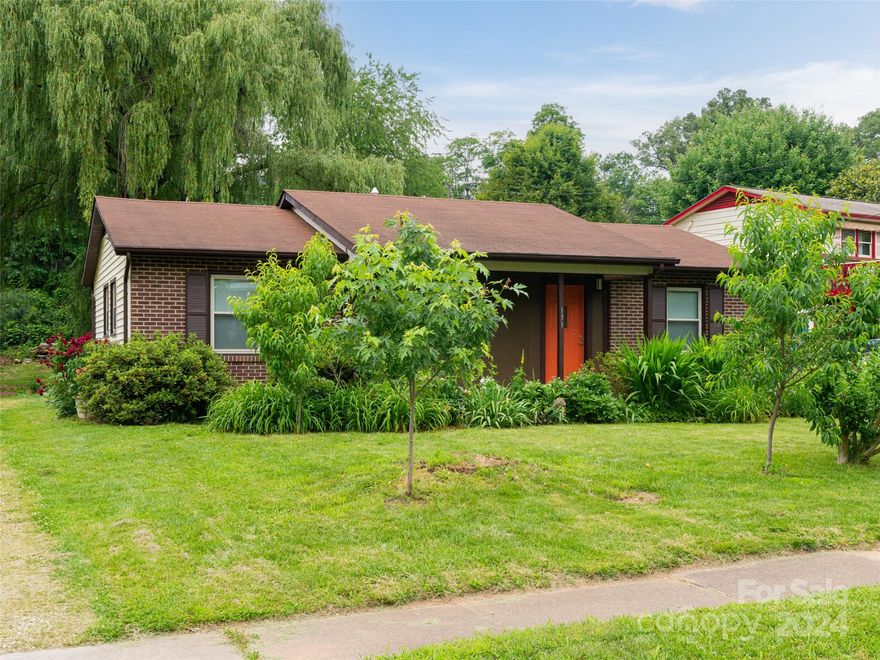 Location Location Location!!!!! This is a great home close to all downtown Asheville offers. One level with engineered hardwood, open living area with lots of natural light, leading to kitchen with stainless appliances, gas range, live edge shelves, granite counter tops, and apron sink. Enjoy the outdoors with large back deck off dining area, level yard with lots of sun and fruit trees. Primary bedroom ensuite offers curbless tile shower, additional ample size bedroom and bright guest bath with tile surround. Recent updates also include plumbing, wiring, dual fuel HVAC, and Navian tankless water heater. Additional flag lot available with purchase, see listing #4151184.