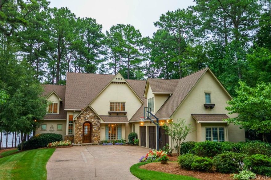 Stunning waterfront home built by Kingswood Homes. This home offers exposed beams, stone fireplace, open concept living, owners suite on main level, hardwoods, and covered terrace with expansive channel views. 4 generously sized bedrooms on second level plus media/rec room with exposed beams. 5th bedroom over garage is a private suite. Two office spaces or one library & one office offered on main level. Enjoy a covered seating area on the water and dock with slip & boat lift. Great community!