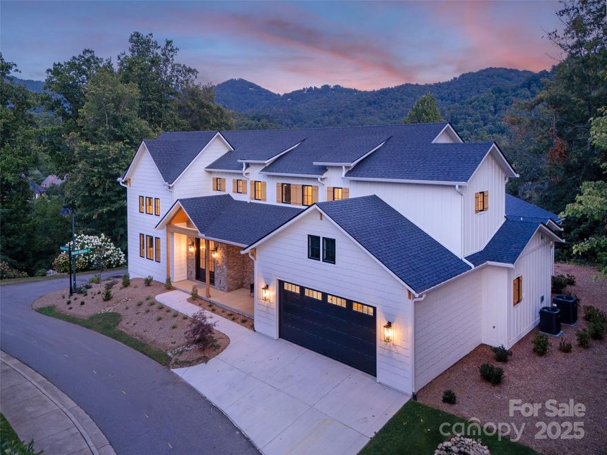 Stunning new construction in Thoms Estate! This custom-built home in the heart of North Asheville offers main-level living with a spacious open floor plan & high-end finishes throughout. The great room has soaring +20ft ceilings, abundant natural light, & mountain views. The main level primary bedroom featured vaulted ceilings, a natural gas fireplace, & an ensuite bath with walk in shower & soaking tub. The laundry room, pantry & mud room feature heated floors. Easy entry with age-in-place features including an elevator for access to the second level. Relax on the front porch & take in the mountain views or entertain guests on the large back patio complete with a natural gas stub-out for grilling. Extremely convenient location minutes away from Fresh Market, Ingles, Beaver Lake and the Country Club of Asheville. Vibrant downtown Asheville is less than 4 miles away. Thoms Estate amenities include a gated entrance, walking trails, community garden, pavilion area, & pickleball courts.