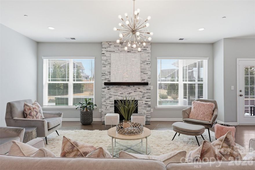 This incredible home has it all! Featuring 5 bedrooms, 4 full baths, and a 3-car garage, this beautifully upgraded home offers over 4,000 sq ft of elegant living space and an amazing backyard retreat. The gourmet kitchen features exquisite quartz countertops, gas cooktop with vented hood, upgraded modern lighting, and a large walk-in pantry with custom shelving. Elegant 44" board and batten wainscoting enhances the two-story foyer, formal dining room, and loft.

The functional floor plan includes a main-level bedroom and full bath, ideal for guests. Upstairs offers a spacious loft, huge bonus room, and an impressive primary suite with dual quartz vanities, soaking tub, separate shower with bench, and a massive walk-in closet with custom shelving. A charming custom pet nook under the stairs adds character and convenience.

Enjoy the private outdoor oasis featuring a screened porch and saltwater pool with sun shelf, jumping rock, waterfall feature, and hot tub. A stone paver walkway leads to the fenced backyard, enhanced with privacy tree landscaping and an in-ground basketball goal.

The 3-car garage includes epoxy flooring, custom storage racks, and a Tesla wall charger. This home combines luxury upgrades with resort-style outdoor living. Must see!

The community will also benefit from the upcoming construction of Jim Ramseur park, which will connect directly to the neighborhood adding even more green space, recreation and outdoor enjoyment just moments from your doorstep.