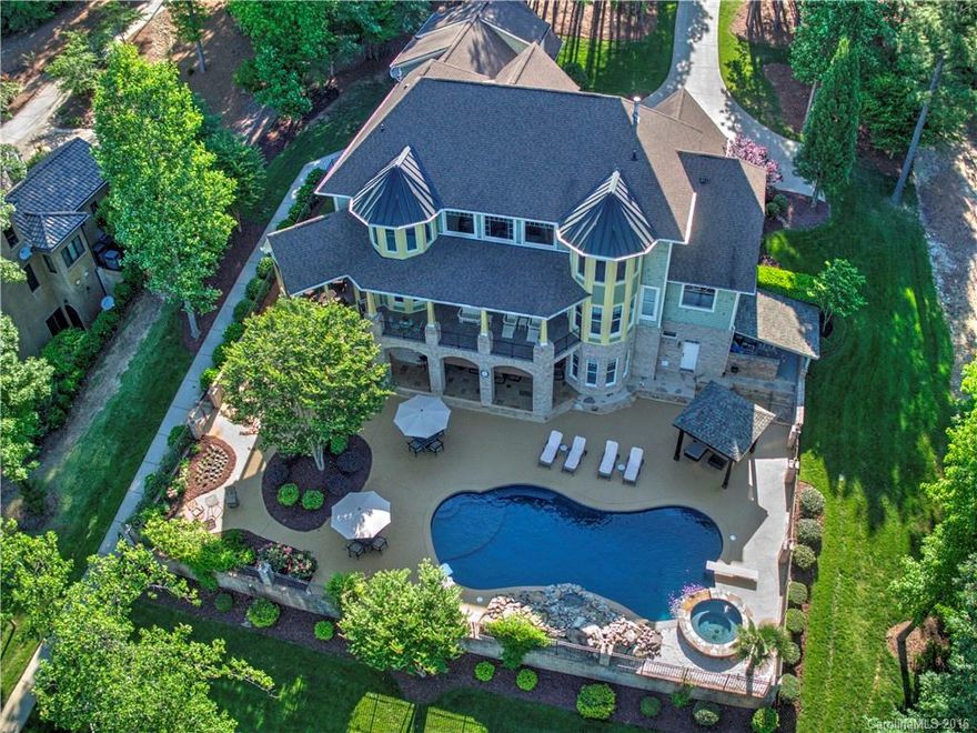 Gorgeous custom cottage style lakefront home on 1.27 acres w/huge resort style outdoor living w/pool, rock waterfall, spa, cabana, fire pit, outdoor grill. Too much to list here. Perfect home to entertain family & friends;2nd living qtrs on lower level, 2 masters, 2 offices, 2 kitchens, covered & screened porches & balconies, media, exercise, den, & elevator for easy access to all 3 levels. 3rd garage bay for golf cart access to path to dock. Beautiful sunset views of lake, trees, & Little Mtn.