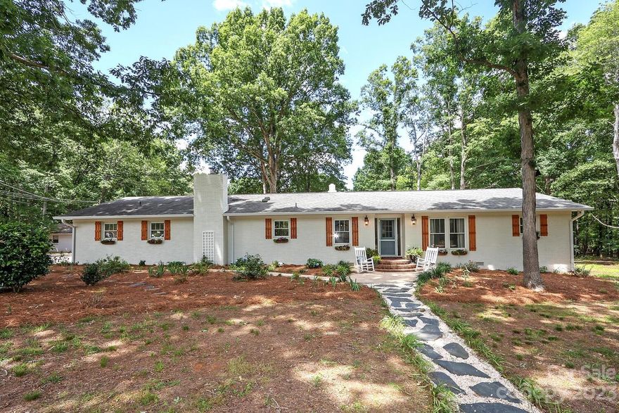 A TOTAL WOW HOME! -4 Bedrooms 3.5 baths on 3.42 acres of beautiful property -  Completely custom remodel in 2022 - Slate stone flooring in kitchen and laundry - engineered hardwoods in main living - marble flooring in primary bath - large bonus room- updated lighting - built in office - wrapped cedar beams - cedar shutters - a chef's kitchen with custom cabinetry - butcher block counter tops - 48" Italian gas range and custom hood - all new appliances - built in banquette with seating and storage PLUS a scullery -Home has a workshop with 448 sq. ft. with power that has endless possibilities - 2 other sheds are also on property - SALT WATER POOL with a 2022 salt system - Absolutely beautiful nature sanctuary with acres of oak forest -  There is a separate building site on property with county water/sewer in place - Home located between Wesley Chapel and Indian Trail -  Do not miss this home!!!Beautiful!!!