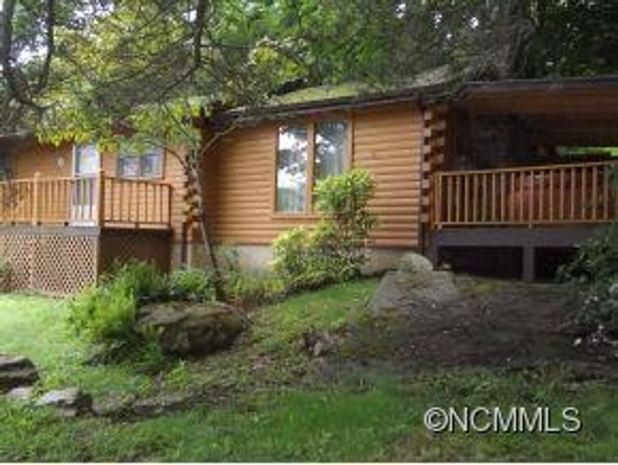 Make Offer ! Reduced $25,000.! Motivated Seller ! Bring Offers ! Log Cabin in Maggie Valley. Wood burning fireplace, covered deck with hot tub. Comes furnished, easy paved access. City water and garbage pick up. Parking is off of  Mill Creek Rd. right at the end of the house. Don't miss this low cost cabin in Maggie Valley !