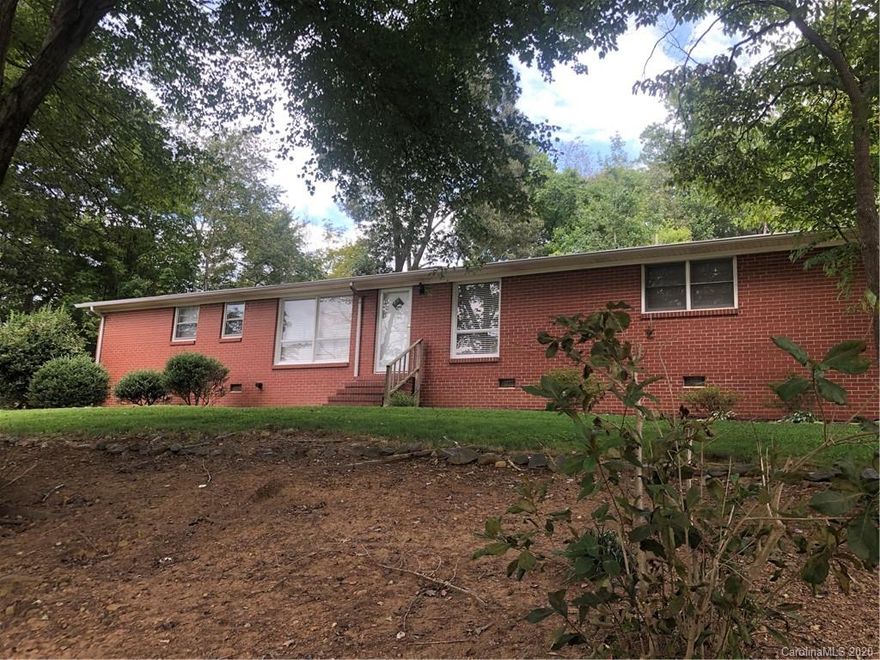 Don't miss this adorable 2 Bedroom, 1 1/2 bath brick home located just outside the city limits. This home comes with an additional lot for added parking. Original hardwoods in the living room, hallway and bedrooms. Large laundry/storage room with utility sink that is also accessible from the carport. Beautiful mature landscaping in the well manicured yard. This one won't last long!