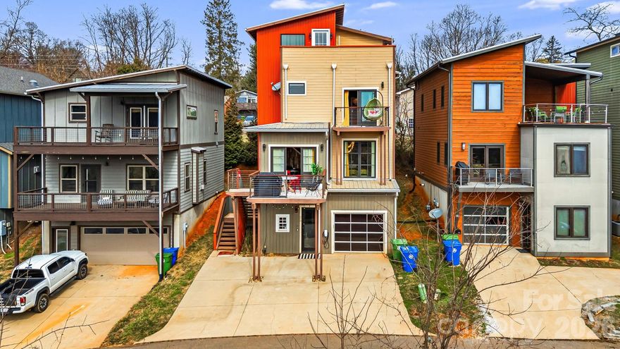 The Luxury Asheville Affair is a bold, experience-driven property positioned just minutes from Downtown Asheville, West Asheville’s culinary corridor, the Biltmore Estate, and the Blue Ridge Parkway. Overlooking the French Broad River and near Carrier Park’s greenway system, this multi-level residence blends vibrant design with large-scale functionality. The home features expansive open living areas, a fully equipped chef’s kitchen, and multiple themed entertainment spaces including a neon-lit lounge with DJ station, karaoke setup, poker table, and arcade gaming area. A rooftop terrace with private hot tub captures sweeping mountain and river views, while additional decks and balconies provide seamless indoor-outdoor flow. Designed for high-occupancy stays, the flexible bedroom configurations and amenity-rich layout position the property as a standout short-term rental opportunity. With its rare combination of location, capacity, rooftop views, and curated entertainment spaces, this property offers exceptional income potential in one of Asheville’s most sought-after markets.