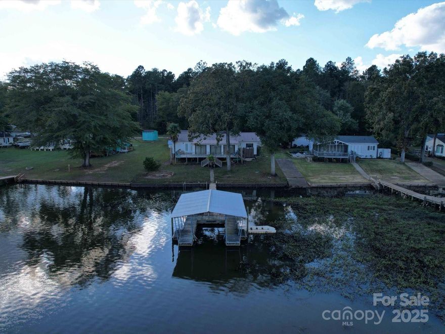This Beaver Creek property sounds like a dream! Picture waking up on the front deck with the sunrise lighting up the water, or pulling in your fishing or pontoon boat right under your private boathouse. With three spacious bedrooms and three baths, there's plenty of room for family and friends. The master suite is a true retreat, featuring an independent water heater, double vanity, and a whirlpool tub, plus direct access to the deck. The sunroom is perfect for enjoying those serene lake views, and the outdoor fire pit is ideal for cozy evenings making marshmallows and memories. With an engineered seawall, outdoor shower and gentle slope to boat ramp and Lake Wateree, this place offers both beauty and functionality. 3 detached garage buildings for all your water toys! Whether you're into fishing, relaxing, or entertaining, this property has it all
Current pics are during winter lake draw down by Duke Energy.