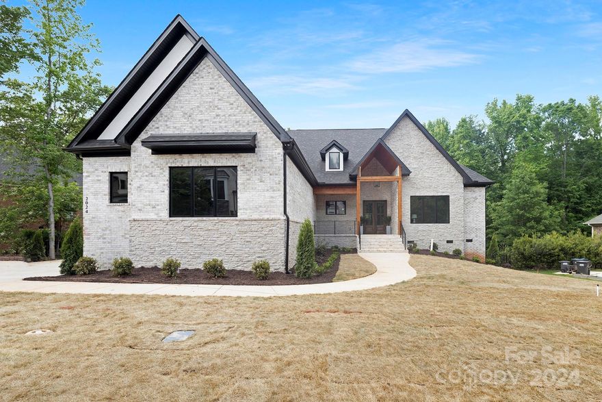 Seller offering $50,000 in credit towards closing costs/rate buydown with acceptable offer!! Beautiful new built custom home in the desirable Gardens on Providence.  Custom cabinetry, high end appliances, large island, and a prep kitchen makes this home ideal for entertaining.  Open floorplan living room showcases a gas fireplace, built in & expansive sliding glass doors that open to a gorgeous outdoor living area. Spacious primary suite on the main features luxury bathroom & custom closet! Secondary master and laundry are also conveniently located on the first floor.  Upper level offers 3 bedrooms with ensuite baths and a bonus/rec room.   Downstairs you will find a fully finished basement with an additional bedroom, full bath, office/workout/movie room and a custom wet bar.  Basement great room opens up to another expansive back patio.  Not a detail was missed on this beautiful home located minutes from shopping, dining and entertainment!!