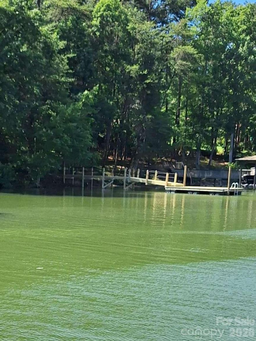 Lake Norman waterfront wooded 0.645ac home site with a floating pier in the Somerset on Lake Norman community. 122' of water frontage. County Improvement Permit is already approved a 4 bedroom w/basement septic. Also the Well Permit is in hand. (Both don't expire until 2030). No time limit to build. Bring your own builder when you are ready. Plenty of room to modify pier/dock should you choose. Lake Norman water front properties are proven unbelievable investments. Low HOA dues of only $250/yr. Located on a peaceful cove yet close to big water. Easy distances to Hwy 16 and to I-77. Low Catawba County taxes only. Close to The Village Shoppes at Sherrills Ford. Come and listen to the quiet and enjoy the serene sunrises!