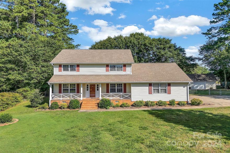 Windsor Forest! This charming 4 bedroom, 2 1/2 bath home is situated on over 3/4 acre in this beautifully established neighborhood. A rare find! Over 2,100 sq ft of living space with a detached garage/workshop, 2-car attached carport, and fenced back yard. The expansive rocking chair front porch greets you with a warm welcome. The large living room with gas log fireplace flows easily into the eat-in kitchen. Formal dining and a spacious den with built-ins, walk-in laundry, and a powder room complete the main floor. Four nice-sized bedrooms are on the second level, including the primary suite with a huge walk-in closet and walk-in attic. The fenced back yard provides plenty of space to relax, dine outdoors, or entertain family and friends. The 24’x24’ workshop has remote garage door entry as well as a walk-in door, offering room to store additional vehicles, lawn equipment, hobbies, you name it! Great location, just a short drive to downtown Spartanburg, restaurants, shops and schools.