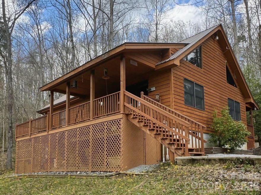 This beautifully crafted mountain home offers the ideal combination of comfort, natural beauty, and convenience, making it a perfect retreat or full-time residence. Designed with both functionality and charm in mind, the home features an inviting open-concept great room with warm wood flooring and an abundance of windows that fill the space with natural light, creating a bright and welcoming atmosphere throughout the day. Just outside, a covered front porch provides a peaceful setting to relax and take in scenic views of the Tuckaseegee River flowing below the property.

Situated on a gently sloping, wooded lot, the property requires minimal maintenance, allowing you to spend more time enjoying the surrounding mountain lifestyle. The home is connected to Tuckaseigee Water and Sewer, offering reliable utilities as well as the flexibility to expand the cabin if additional space is desired. With no HOA fees or restrictions and easy access via paved, state-maintained roads just 200 yards from US 23 & 441, the property combines privacy with convenience.

Inside, the main level features two generously sized bedrooms, each with its own walk-in closet and private bathroom, providing comfort and privacy for residents and guests alike. The upper level offers a versatile open loft space that can serve as an additional bedroom, office, or hobby area, along with a half-bath and access to heated and cooled attic-style storage. Recent updates include a new metal roof installed in 2022 and a new electric hot water heater installed this year, ensuring modern reliability.

The location offers exceptional access to outdoor recreation and local attractions. The nearby Tuckaseegee River is well known for its catch-and-release dry fly trout fishing from October through May, as well as opportunities for rafting, kayaking, and tubing during the warmer months. The charming town of Dillsboro is just minutes away, offering a variety of restaurants, breweries, and historic appeal, while Sylva is approximately one mile from the property. Additional nearby destinations include Western Carolina University (6 miles), Cherokee and the Great Smoky Mountains National Park (15 miles), and the Cashiers/Highlands area, all within a short drive.

For added peace of mind, the property is not located within a floodplain and was unaffected by recent storm events. The home also benefits from ample sunlight year-round, with minimal winter accumulation of snow and ice. Lovingly built and maintained by its original owners for over 30 years, this cabin presents a rare opportunity to own a thoughtfully designed mountain home in a highly desirable location.