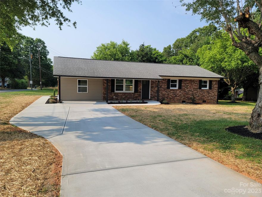 This house is an absolute show-stopper! With 1682 sf you have plenty of space for the family. 3 beds & 2 full baths with a living room plus extra den/flex space. The kitchen is gorgeous white with gold hardware and fixtures, all new SS whirlpool appliances, solid white quartz countertops, lots of can lights, and large peninsula. Maple colored waterproof LVP throughout entire home. Both bathrooms have stunning black vanities with gold hardware. Primary bath includes a custom tiled walk-in shower while the hall bath has a tub/shower combo with custom tile surround. Spacious 3 bedrooms that include ceilings fans. This house was taken to the studs and includes new electrical, plumbing, sheetrock, interior & exterior doors, hardware, sliding back door leading to the back deck, all new concrete drive & sidewalks water heater ,etc. And was meticulously renovated by a licensed contractor. All permits were pulled with Gaston County. No detail spared on this one. Don't underestimate this house!