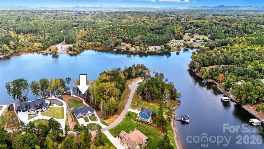 Luxury waterfront living on Lake Hickory in the gated and private Waterfront Harbor community. This stunning new construction home is situated on a 0.86-acre lot and thoughtfully positioned to capture expansive lake views from nearly every room, offering exceptional privacy and a peaceful, low-traffic setting.

The 1.5-story home with a partially finished basement features an open-concept main level designed for both entertaining and everyday living, allowing for comfortable one-level living with the primary suite and main living areas on the main floor. The designer kitchen includes custom cabinetry, a grand island, built-in refrigerator, double oven, gas cooktop, and high-end finishes throughout, seamlessly flowing into spacious living and dining areas overlooking the water.

The main-level primary suite offers a private retreat with dual walk-in closets and a spa-inspired bath. Two additional main-level bedrooms share a beautifully finished full bath, complemented by a half bath, laundry room, and two-car garage. Upstairs includes a loft, fourth bedroom, movie room, dedicated office, and full bath, along with an unfinished attic for storage.

Outdoor living is a true highlight, featuring a covered patio with an outdoor kitchen and firepit, ideal for entertaining or relaxing lakeside. A gentle paved path leads to the private double-decker dock with boat lift, allowing for immediate enjoyment of Lake Hickory and unforgettable sunset views — no waiting period required. The partially finished basement adds a large family room, full bath, ample storage, and an additional garage bay ideal for lake gear or a golf cart.

Located outside the city limits, the home benefits from lower property taxes, while still being just two miles from grocery stores and medical facilities for everyday convenience.

With a low annual HOA of $500, and located approximately one hour from Charlotte and within approximately one to one-and-a-half hours of Asheville, the Blue Ridge Mountains, Boone, and Banner Elk, this rare new-construction waterfront home offers the perfect balance of luxury, privacy, and accessibility. A refined lake lifestyle, ready to be experienced.