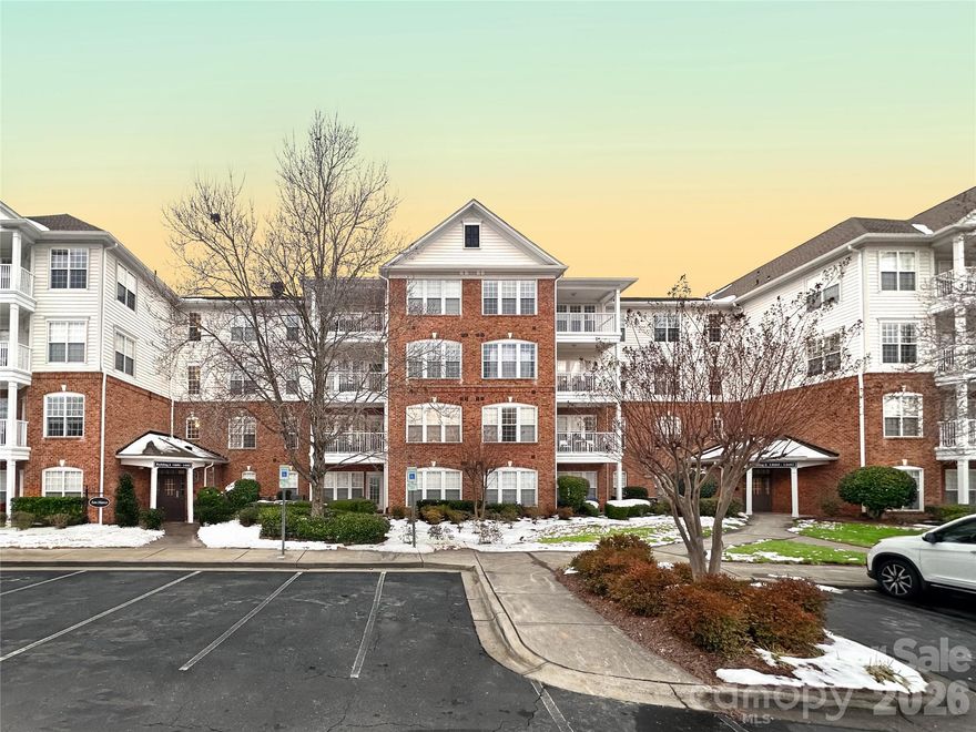 Located in the heart of Ballantyne within the gated Belle Vista community, this beautifully appointed three-bedroom residence is a must-see. Enjoy the convenience of private exterior access in addition to secure building entry. The open-concept living space features a large, expansive breakfast bar, dedicated dining area, and an inviting living room centered around a gas fireplace—perfect for everyday living and entertaining. Brand-new carpet and fresh interior paint.   The utility room offers additional storage and includes a washer and dryer for added convenience. The spacious primary suite is thoughtfully separated from the secondary bedrooms and features a tiled shower and a generous walk-in closet. Heavy moldings and decorative niches add architectural interest and character throughout the home.
Step outside to the private patio overlooking the pond with a tranquil fountain, where you can enjoy peaceful water views and beautiful sunset skies. Located in the San Marco building & just steps from Ballantyne Village and across Johnson Road from Ballantyne Bowl, this home offers exceptional convinces with restaurants, entertainment and shopping nearby. It the ultimate South Charlotte lifestyle—ideal as a primary residence or an investment opportunity.