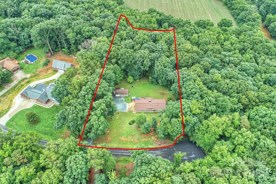 Remarkable deal priced way below market value!  Move in ready. This exceptional home on 2.51 acres in Union County offers serenity and comfort with no HOA! Douglas Fir wood siding, 2018 architectural roof, newer HVAC system (2014), this well-maintained home offers an upgraded kitchen with elegant granite countertops, solid oak custom cabinets, and newer appliances. Both full baths have been upgraded, and all bedrooms offer walk-in closets. New vapor barrier in the crawl space. One car attached garage with large storage room and detached garage with workshop. Additional square footage includes screened porch, detached garage and workshop.5 minutes to Wingate University and easy access to 74 bypass - only 20 minutes to Matthews.