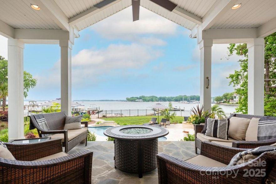 Welcome to a truly rare waterfront masterpiece, where breathtaking Lake Norman views will unfold from both the front and rear of this extraordinary custom retreat!! Gracefully appointed with timeless stone accents and a generous 3-car garage, this home blends refined luxury with tranquil lakeside living. Inside, expansive windows frame serene water vistas from nearly every room. The gourmet kitchen is a showpiece, featuring an oversized island, hidden walk-in pantry, quartzite counters, beautiful cabinetry, and professional-grade appliances. The sumptuous primary suite is a private haven with a spa-caliber bath and curated designer closet. Step onto the covered porch with a striking stone fireplace—perfect for morning coffee or unforgettable gatherings. With room to add a pool, this premier lot invites the ultimate resort-style experience. Every inch of this home will be crafted to inspire, indulge, and impress!!  Photos are representative.  Pricing may vary based on selections.