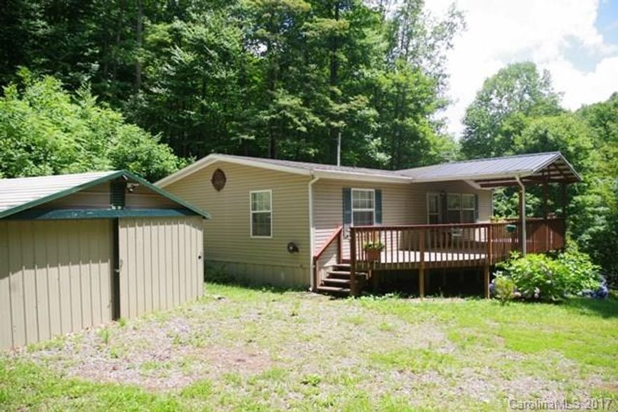 Cool high elev 2BR/2BA Clayton DW home in excellent condition on 12.86 acres of wooded mountain land and furnished! Open great room w/sunny kitchen/dining area. Wood burning FP in living room w/bedrooms/baths across the hall from each other. Large deck overlooks tumbling waters of Roaring Fork Creek audible from the house and fronts the property. Nice, open grassy yard. Large garage/workshop, several sheds and a spring house. 4-wheeler trails on property w/several deer stands. Lovely location.