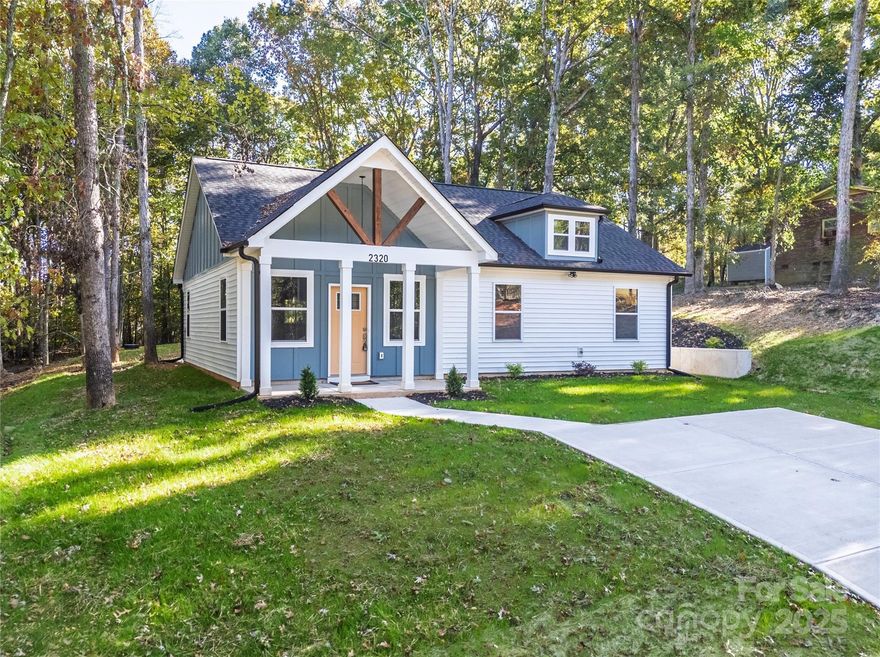 This breathtaking new construction home is nestled on a large secluded lot surrounded by mature trees, offering  exceptional privacy in a peaceful natural setting. You'll be greeted by the vaulted front porch welcoming you in the home with extended height cathedral ceilings and open floorplan with lots of windows inviting natural light and scenic views of the surrounding landscape. LVP floors seamlessly lead you into the gorgeous kitchen with peninsula and bar seating, granite ctrs, soft close cabinetry, farmhouse sink, tile backsplash and hood vent, while the dining area invites you through the sliding glass doors to the private patio. At the end of the day, relax in the amazing primary suite with tray ceiling, accent wall and LVP floors. No detail has been overlooked in the unbelievable primary bath showcasing an oversized tile & glass surround shower with rainfall, tile floors and dual vanity w/ granite counters. There are 2 add'l bedrooms, ample in size, plus hall bath w/ tile surround shower, granite counter & tile floors. Additional highlights include a .47 acre lots that feels triple the size, dedicated laundry room, no carpet - all tile & LVP floors, connected to public water, no HOA, plus so many upgrades and custom features for this amazing price! You'll appreciate the quality construction and elevated finishes - not an average cookie cutter home! 10-year Structural warranty included, pay ONLY County taxes and close to everything you need - 1.5 miles from John Moss Lake, 2.5 miles from E Dixon Blvd, 5 miles from downtown Shelby, 14 miles to Gardner Webb University. *USDA ELIGIBLE with no down payment. You may also qualify for up to $20,000 in down payment & closing cost assistance! Call preferred lender for details!