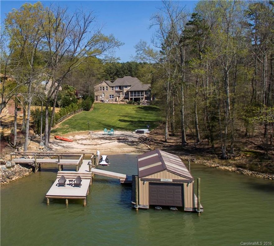 Privately gated waterfront Estate with separate huge 1300+ guest house included in sq footage and oversized second garage. Resort style backyard with saltwater pool and hot tub, waterfall and outdoor fireplace. Screened porch and lower covered porch, new boat lift and remote garage door on boat house as well as trex dock. Sandy beach and floating dock. Security system with camera. 2015 taxes were $2,739 Clover schools, no HOA fees. Total sq ft. 6000+