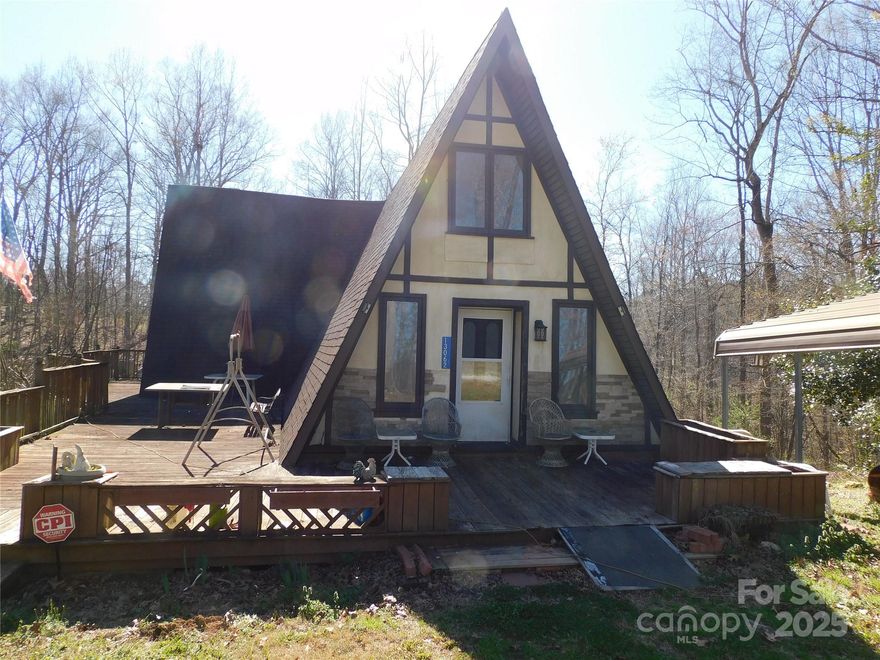 One of a kind "A" Frame home with  fully finished walkout basement featuring over 2900 heated square feet of living space.  Main floor with 1 bedroom and bath living area kitchen and dining.  2nd floor features 2 small bedrooms and a full bath.  The basement is fully finished and has 3 bedrooms and 3 full baths along additional sun room and storage rooms with 3 exterior doors. Waters is supplied from an artesian well and spring. Total of 3.84 acres. Spacious yard  with carport and storage buildings.  The remaining property features large hardwoods and nice creek with artesian spring well.   This unique property is solid and well built but needs a little love and care to make it shine to its maximum potential.  Deeded right-of-way to the property from Highway 55.