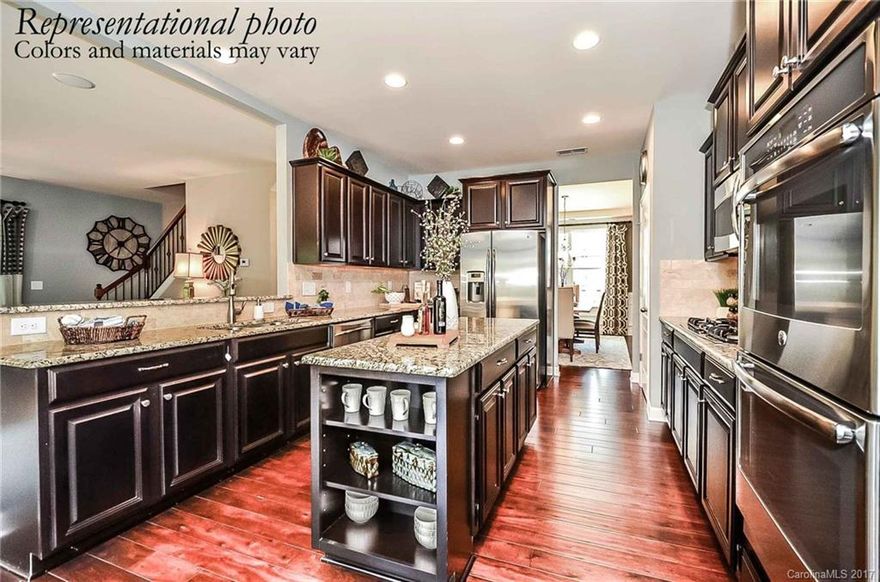 NEW home offered in this established community. 2nd Master on the main level w/master upstairs, gourmet kitchen featuring double convection wall ovens w/5 burner gas cooktop, granite in kitchen & all full baths, off white/glazed cabinets w/molding & hardware, rear staircase w/wrought iron railing, deluxe master bath w/tiled shower & built-in seat, large single-bowl kitchen sink, finished 3rd floor w/bedroom/full bath & huge bonus room...on a wooded site! 3 car garage!