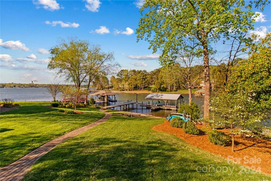 Serenity and a view! This beautiful home has been meticulously updated for maximum enjoyment. You will appreciate the thoughtful way each improvement was made, both inside and out. In the last year the kitchen was completely remodeled with brand new cabinetry, GE Cafe appliances, a massive island with seating and a coffee bar - it is stunning! Tucked away behind the kitchen is a large area that can be used as a mud room, or a nice quiet area to read or work. The entire home was just repainted and there is new flooring (high end LVP in living areas and carpet in bedrooms)-even the staircase was redone!  There are 3 bedrooms (per the septic) but the lower level den has a full closet and close access to a full bath.  Wait until you see the outside!  The wrap around rear covered deck is the perfect place to enjoy the views.  The covered dock was updated in 2020 with new floats and decking. Everything these owners do, they do right - not just what you see, but also what you can't see.