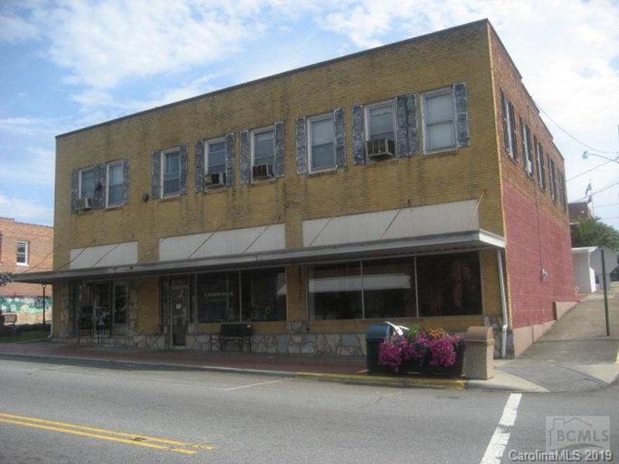 Multi use building. Frontage on Main Street consist of former law office and a beauty shop. Behind that is a nice 1898 square foot owner/residence with 3 bedrooms and 2 baths attached to the back of the building on Faet Street. . Upstairs over the commercial building are 6 apartments with 2 currently occupied. One of the apartments has a half-bath facility, with 2 community baths down the hall. Rents have been $500/mo for law firm an currently $400/mo for beauty shop. Call listing agent for more info an to schedule showing
