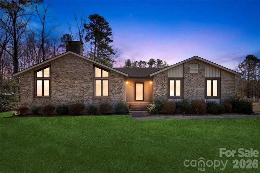 Natural light, vaulted ceilings, and a statement stone fireplace make this Albemarle home truly special. Located on an almost half-acre corner lot in Anderson Heights, this 3-bedroom, 2-bath ranch offers covered front and back porches, perfect for relaxing and enjoying the peaceful setting. Inside, oversized windows and soaring ceilings create a bright, open feel throughout the main living area.

The property also offers exceptional flexibility with a two-car attached garage plus a detached garage/workshop with lean-to, ideal for hobbies, storage, boat parking, or a home workshop. No HOA and plenty of room to make the space your own. Convenient to Albemarle shopping, dining, and everyday services.

Homes with this much character and flexible workspace are hard to find—schedule your showing and come see it for yourself.