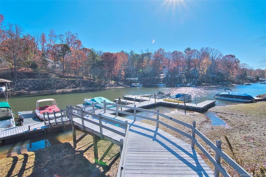 Enjoy your own dock just steps away in Neptunes Landing at Tega Cay. Beautifully updated home with gorgeous hardwood floors. Formal living & dining. Wood burning fireplace. Surround sound. Kitchen w ss appliances, custom backsplash & sandstone counters. Upper level master w private balcony & walk in closet. Spacious secondary bedrooms & full bath. Partial basement w 4th bedroom/bonus. Bike racks in garage. Fenced backyard. Front yard features natural area w stone path & fire pit.