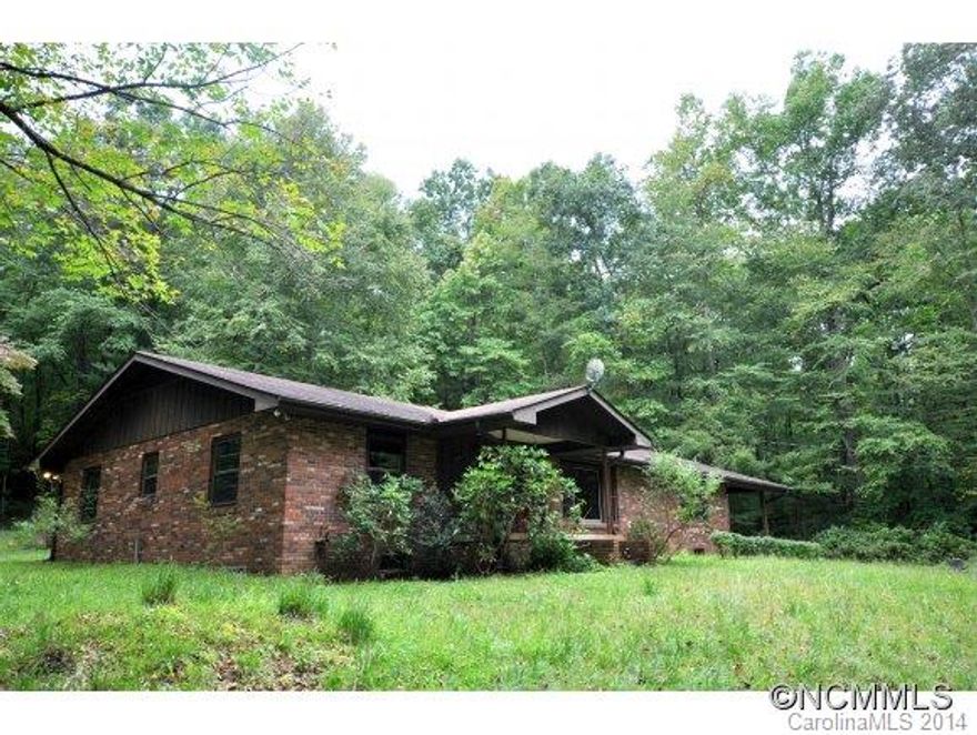 Sale also includes adjoining lot at Deed Book 562, page 463. Very private wooded acreage with stream along the border. The brick home is currently handicapped accessible, has 2 brick fireplaces, master suite, kitchen has a center island with large pantry.  Includes a carport and covered porch.  Needs some work & updating.  Property is being sold "AS IS".