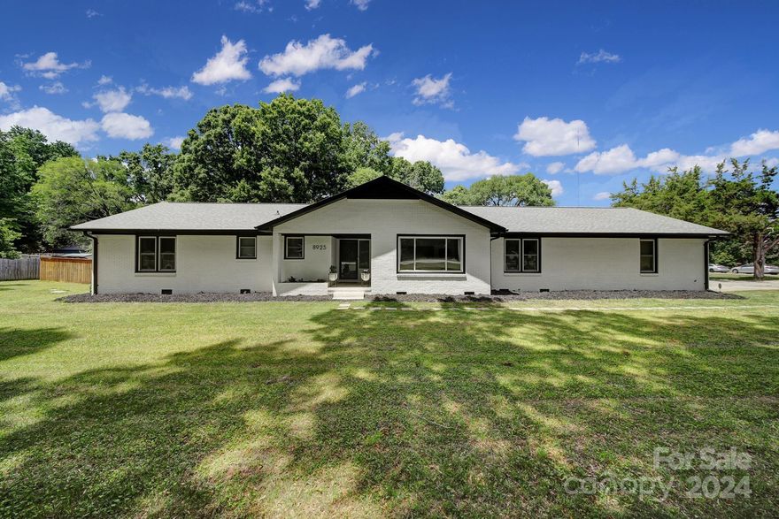 On just shy of an acre, this brick ranch has been revived w/numerous updates inside & out while still allowing the new owner to add their own finishing touches. Notice its curb appeal right away w/a large corner lot, white painted brick contrasting the black trim, garage doors & gutters. Inside, find an entryway leading you into the newly updated interior with light pine LVP flooring throughout, highlighted by the natural sunlight beaming thru the windows. New matte black hardware, light fixtures, & ceiling fans add modern elegance. In the large kitchen, butcher block countertops have been added to compliment the farmhouse sink & upgraded appliances. Step out to the sunroom overlooking the enormous flat backyard w/a cedar-stained fence to provide great privacy. Featuring modern conveniences like AT&T Fiber internet, Nest thermostat, security system w/cameras, don’t miss out on this opportunity to make this prime location in Charlotte home. Back on market due to no fault of sellers.