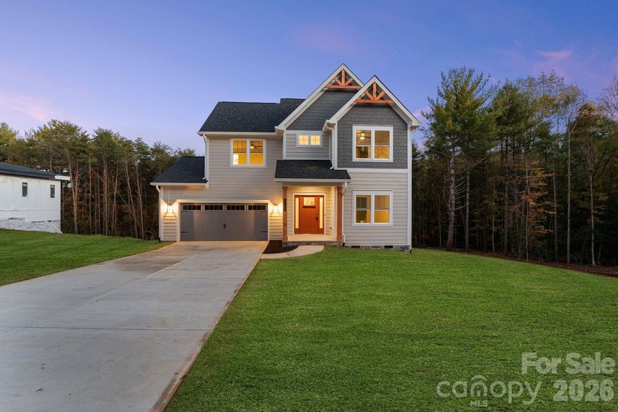 An exceptional luxury new construction opportunity in Hickory’s sought-after Northlakes community. This beautifully crafted residence showcases the ideal balance of modern design, timeless finishes, and true custom workmanship, standing apart as one of the most refined new builds to hit the Hickory market!

Positioned on over 0.65 acres, the setting offers a rare sense of privacy and space, with a serene wooded backdrop and no homes behind you. Enjoy the freedom of no HOA, while still being just minutes from shopping, dining, schools, and community boat access to Lake Hickory - the perfect blend of peaceful living and everyday convenience.

Inside, the home immediately impresses with soaring vaulted ceilings, an open and airy layout, and elevated finishes throughout. Luxury flooring, custom trim and millwork, and a striking solid white oak staircase establish a sense of quality and craftsmanship rarely found in new construction at this level. The chef’s kitchen is both functional and stylish, featuring Bosch stainless steel appliances, custom cabinetry, quartz surfaces, and designer lighting ideal for both entertaining and daily living.

The thoughtfully designed floor plan offers flexibility for today’s lifestyle, including a main-level suite perfect as a second primary bedroom, guest suite, or private home office. Upstairs, the primary retreat feels like a private sanctuary, highlighted by a spa-inspired bath with a custom tile shower, designer fixtures, and an oversized walk-in closet. Each additional bedroom also features its own generous walk-in closet, providing exceptional storage throughout the home.

Every detail reflects a commitment to quality - from architectural accents and handcrafted finishes to premium lighting and material selections chosen for both beauty and longevity. This is a home built with intention, precision, and lasting value in mind.

Located in one of Hickory’s most desirable areas, this property delivers modern luxury living with quick access to Lake Hickory recreation and the conveniences of town. Opportunities like this are rare! A luxury new construction home on over half an acre, surrounded by trees, offering no HOA and Lake Hickory access!

*1% lender credit available when using preferred lender*