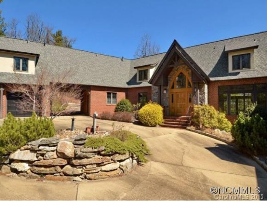 If you like elegance & privacy  take a look at this Brick and Stucco Tudor. Drive thru the entrance way to the courtyard. Notice the craftsmanship of this great home as you approach the custom mahogany front door to the details inside, hand forged light fixtures, solid brass door knobs & hardware, custom FP mantels of solid oak & cherry, oak cabinets, granite counters soaring ceilings thru-out. PRICED $260,000 BELOW TAX VALUE!!