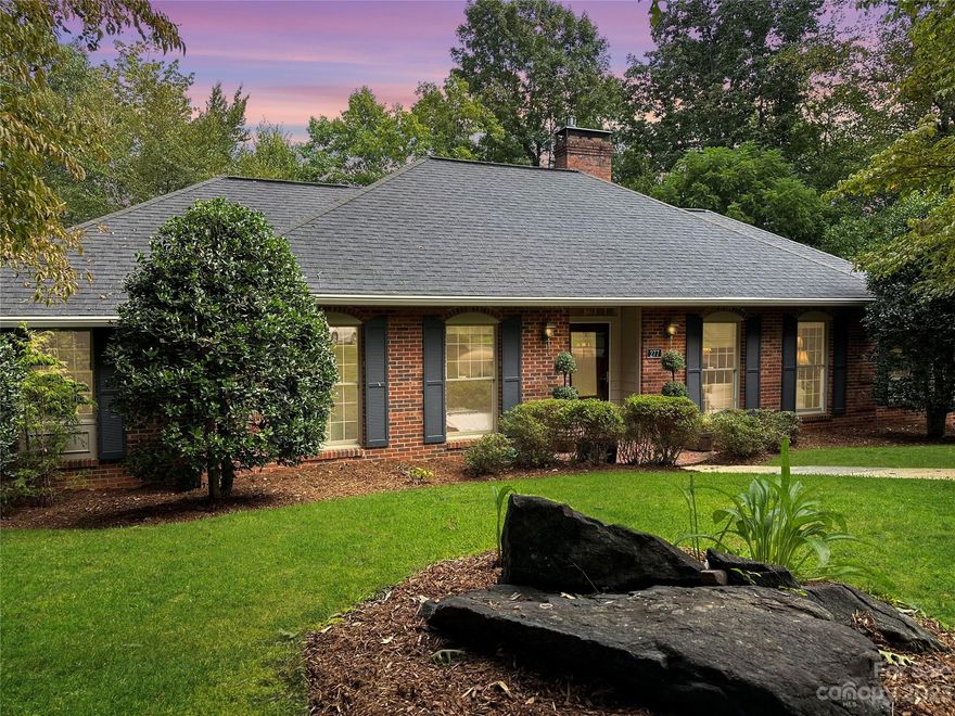 Nestled in the heart of our premier in-town neighborhood, this classic 5-BR brick traditional home exudes timeless elegance and charm. Boasting a combination of tasteful updates and original character, this residence offers the best of both worlds for discerning buyers seeking a comfortable and luxurious lifestyle.  Upon entering, you'll be greeted by a gracious foyer that leads to spacious living and dining areas adorned with large windows that flood the home with natural light. The well-appointed chef's kitchen features high-end appliances and countertops, and a bar area perfect for culinary adventures and casual dining.  The main level also includes a cozy family room with a fireplace, making it the ideal spot for intimate gatherings or relaxing evenings with loved ones. The lower level gives secondary living if so desired with a second kitchen, den, bathroom, and 2 bedrooms. The rear patio overlooks the woodlands below.  The lot is ultra private on an unusually large 2.37 acre lot.