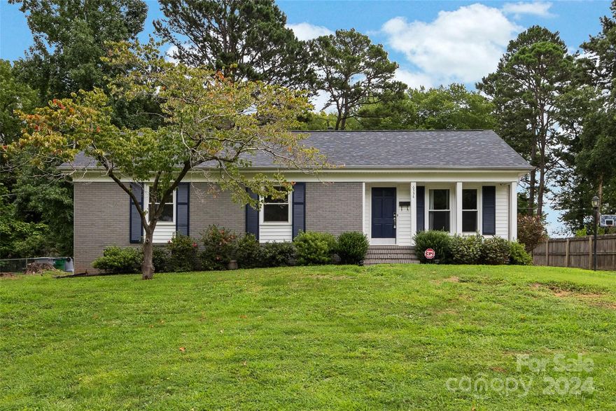 Welcome to 6334 Beecher Drive! This precious updated 3BR/2BA brick ranch home in Hampshire Hills features hardwood floors throughout, tile in the kitchen and baths, and neutral paint. The open floor plan includes a kitchen with tile floors, granite countertops, updated khaki cabinetry, a cool wooden bar top area and stainless appliances. The large dining room and bright living room with a coat closet offer ample space. The primary bedroom has an updated bathroom with a tub/shower. Two additional bedrooms share an updated hall bath. The home has vinyl windows and a new roof in 2022. The laundry room off the kitchen provides extra storage and a side entrance. There is a large fenced backyard, a storage shed and covered rear porch that's nice in the sun or the rain! Enjoy the nearby Unity Neighborhood Park with tennis courts, recreation areas, and a playground. Convenient location - easy access to Uptown, NoDa, or even up to UNCC.  Come see it today! Showings start Friday 8/9