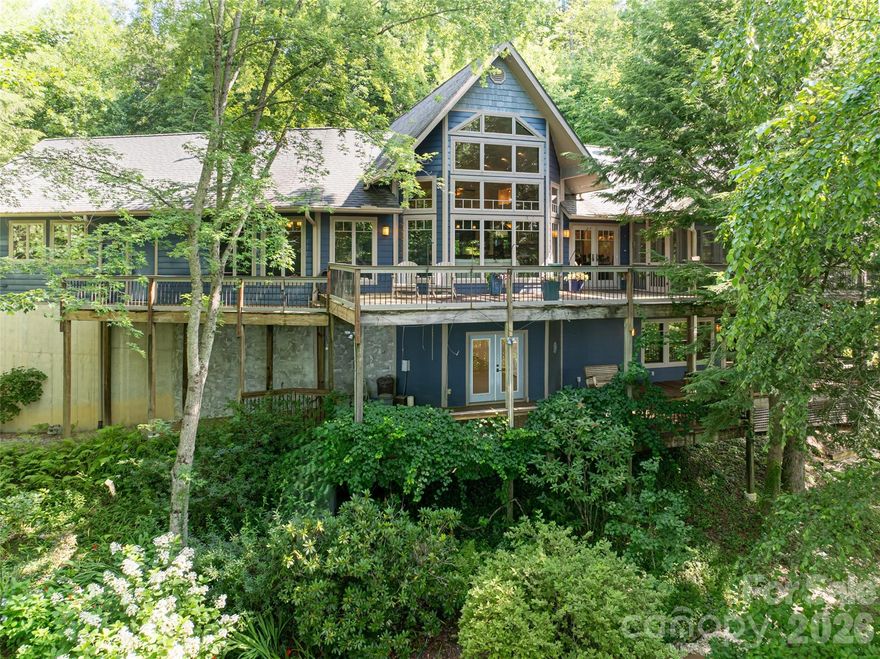 Discover this stunning custom-built mountain home just minutes from charming Saluda and a short trip to Flat Rock, NC. Nestled among the trees with long-range views to Panther Mountain, it offers remarkable privacy with the comfort of nearby neighbors. Enjoy exceptional main level living and a rare blend of openness and seclusion, with thoughtfully designed spaces to meet every need. The chef’s kitchen is meticulously crafted with custom cabinetry, butler’s pantry, Five Star six-burner gas stove and more. A striking two-sided stone fireplace warms both the great room and dining area, creating year-round ambiance. The primary suite is a tranquil retreat with a private den and fireplace. The library with full bath and a Murphy bed provides that other room on the main floor other homes lack. On the lower-level space for family and guests and a large workshop/studio (semi-finished 623 sq') completes this extraordinary retreat. Enjoy outdoors on sun lit Ipe decks, a screened-in porch, and serene Zen-like gardens.