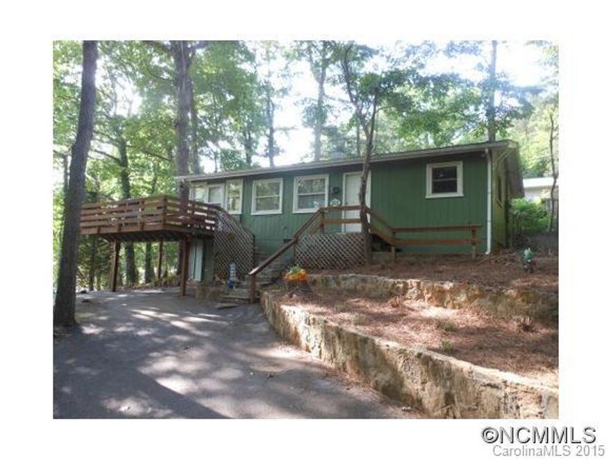 This vintage 2 bedroom, 1 1/2 bath would make a great weekend retreat or full-time residence.  The views from the deck across to the lake are superb.  Enjoy the wooded low maintenance lot and privacy of the forest behind.   The hard wood floors, an open kitchen, large master bedroom with built in storage, are just some of it's features. Ample parking and access to the lake's ramp for your boat are assets in this lake community.