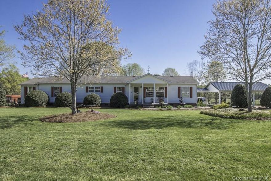 Must see this beautiful home nestled on 8.17 professionally landscaped acres.  Move in ready w/spacious living areas, large kitchen, master bedroom has walk in closet, sitting area & double sinks in the bathroom.  Enjoy your morning coffee on the inviting screened in porch overlooking the back yard.  Have your own business...we have you covered! 3 buildings you must see w separate gated driveway! One has meeting room space & bathroom & all have water and electric.  Don't miss the greenhouse too!