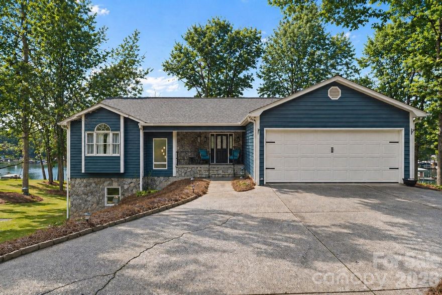 Experience the best of Lake Norman living on this private 2.66-acre waterfront retreat featuring an impressive 400 feet of shoreline. This refreshed 5-bedroom, 3-bath ranch with a fully finished walk-out basement offers a seamless blend of comfort, space, and modern updates.  Beautifully refined landscaping and a new deck create inviting curb appeal, while inside, the open-concept main level showcases refinished hardwoods, a spacious kitchen island, stainless steel appliances, and effortless flow into the living area - ideal for everyday living and entertaining.  The main level is designed for true one-level living, featuring a primary suite, guest bedroom, full bath, sunroom or office, and laundry room. The lower level expands the home’s versatility with a large bonus room anchored by a wood-burning fireplace, three additional bedrooms, and flexible spaces for recreation or gatherings. Multiple storage areas, including a wet storage room, are perfectly suited for lake life.  Outdoor living is maximized with a main-level deck, covered patio, fire pit area, and private covered dock with boat lift - creating the ultimate setting to enjoy the water year-round. The expansive lot offers additional usable space with room for a future detached garage, RV storage, or outbuilding - the possibilities for the extra waterfront land are endless!  A rare opportunity to own a private, acreage waterfront property on Lake Norman with endless potential for relaxation, entertaining, and long-term enjoyment.  No HOA