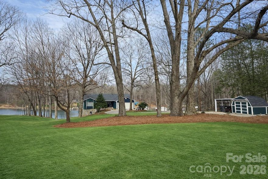 Welcome to this beautiful lakeside retreat nestled on 2.66 acres offering 400' of Lake Norman shoreline. This 5-bedroom, 3-bath ranch home with a fully finished walk-out basement offers a thoughtful blend of comfort, space, and modern updates. Refined landscaping, a new deck, and inviting curb appeal set the tone upon arrival. Inside, the open-concept main level flows seamlessly from the kitchen to the living room, featuring refinished hardwood floors, stainless steel appliances, and a spacious kitchen island ideal for everyday living and entertaining.
The main level includes a primary suite, guest bedroom, full bath, a sunroom/office, and laundry room, providing true one-level living convenience. The fully finished lower level expands the living space with a large bonus room featuring a wood-burning fireplace, 3 additional bedrooms, and flexible areas for recreation or gatherings. Multiple storage rooms including a wet storage area, ideal for waterfront living needs making lake days easier. Outdoor spaces are designed to maximize the lake lifestyle, offering a main-level deck, covered lower patio, dedicated fire pit seating area, and a covered dock with boat lift. The 2.66-acre lot provides additional usable land with potential space for future storage buildings, RV parking, or a detached garage - the possibilities are endless. A rare opportunity to enjoy peaceful Lake Norman living with room to relax, entertain, and create lasting memories.
