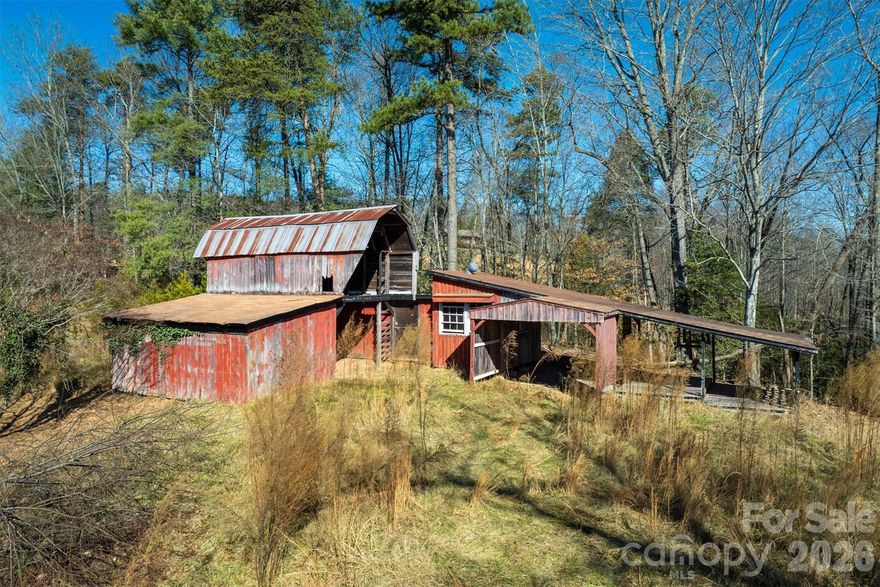 PRICED UNDER $225K — AND THE VIEWS ARE FREE! Wake up to sweeping North Carolina mountain views from your own private acreage. Hardwood trees, a 4-stall barn with shop area, and just enough distance from the world to finally breathe. Wildlife is your only neighbor. Whether you're dreaming of a weekend escape, a renovation project, or an investment opportunity — this is the one. Property includes a mobile home (no VIN on file). The right buyer with the right vision will turn this into something special. Opportunities like this don't come along twice. Come see it for yourself.