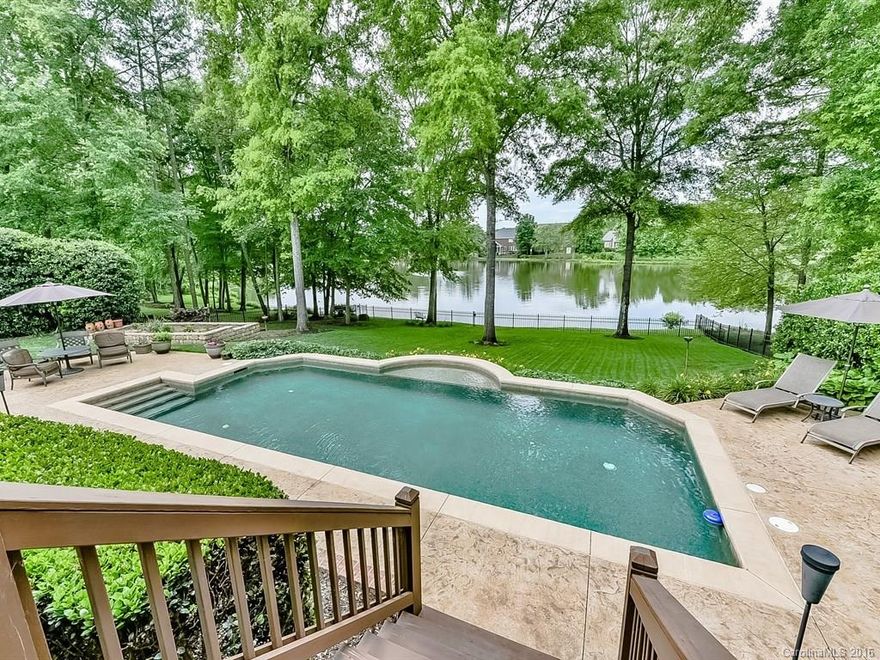 WOW-come see one of the best settings around! Beautiful home on a GORGEOUS lot. Custom home w/open floor plan. New hardwoods, fresh paint throughout. Kitchen has island w/gas cooktop and wall ovens. Butler's pantry/wet bar between kitchen & dining room. Great master suite w/large walk in shower & garden tub. HUGE bonus room. And then the back yard...oh my. Sit on your screened porch and take it in. Saltwater pool, outdoor fireplace, lush landscaping, fully fenced in yard. A true WATERFRONT lot!