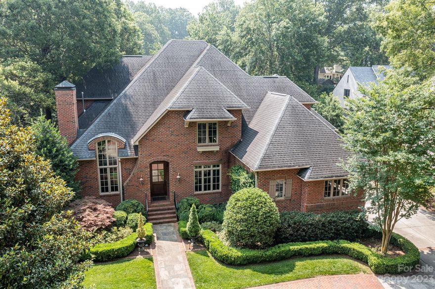 Stunning all brick home conveniently located in Myers Park, minutes from both Downtown and the Southpark area.  10 ft ceilings down w/ gorgeous moldings and meticulous attention to detail throughout.   Formal Living Room with fireplace and soaring ceiling and formal Dining Room flank the foyer.   Chef's Kitchen with oversized island, Thermador gas range, walk-in pantry and abundant counter space opens to Keeping Room, Breakfast and Family Rooms- with fireplaces and French doors to the back porch.  Drop zone,  Laundry Room, Private office and 2nd half bath on the back hall off the three car side facing garage.  Primary bedroom is downstairs w/ two walk-in closets, large en suite bath, walk in shower, soaking tub and private water closet.  Upstairs the bonus room boasts another fireplace and lots of space to entertain.  Four additional bedrooms each w/ en suite bathrooms, walk-in closets and heavy wooden shutters.  Private backyard w/ built-in grill, fireplace, and outdoor covered porch.