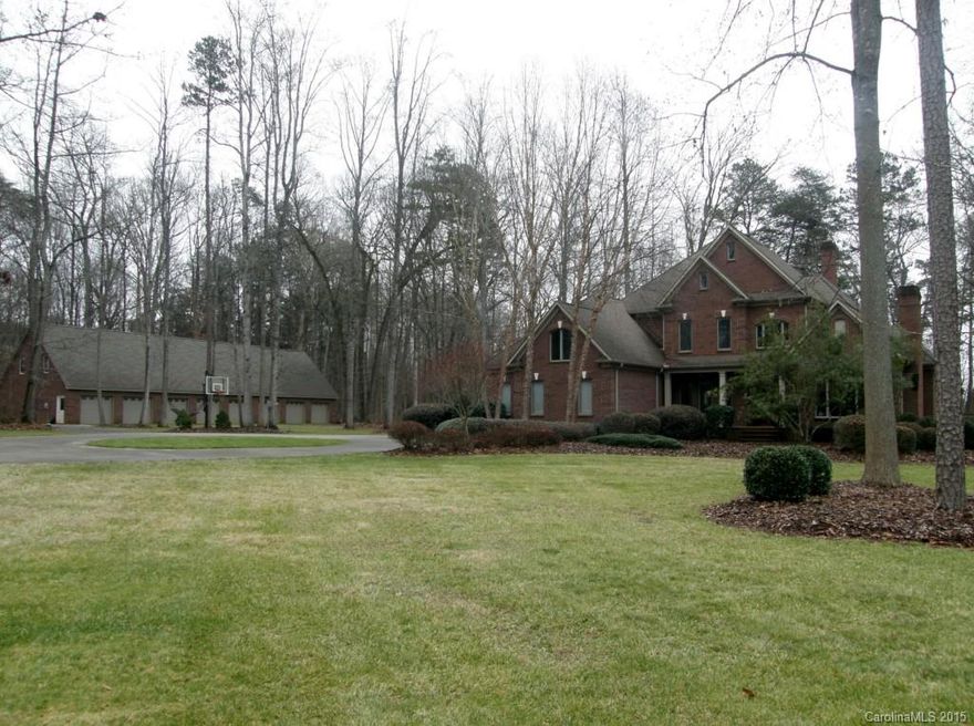 Two story Executive Home on 6.41 private acres, not visible from street. Car collector's Dream! Oversized 8 stall, three sided brick garage w/unfinished attic space.  Can hold 12 cars and still have room to work! Gourmet Kitchen with down-draft cooking surface, stainless appliances and granite countertops.  Beautiful open floor plan features kitchen open to huge, 2 story family room.  Two masonry fireplaces, Master on main featuring lovely master bath. BR #2 w/private bath also on main floor.  Upstairs Bonus room includes stacked stone wet bar with copper countertop - great entertaining space!  Extra large back patio overlooks private back yard.  You've got to see this home!