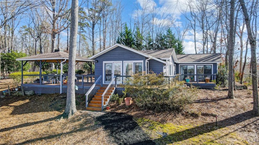 Designed to enjoy lake living and the outdoors, this classic waterfront home offers glorious main channel views, beautiful landscaping, and mature hardwood trees. Perfect for a weekend retreat or full-time living this updated one level home has tons of character, boasting an open floorplan, vaulted ceilings with wood paneling, hardwood floors, lake facing great room, updated kitchen, and updated bathrooms. Engage your inner chef in the beautiful kitchen featuring stainless steel appliances, center island, and plenty of counter space.  The huge wrap around deck, covered porch, lakeside decks, floating swim dock, and covered dock with boat lift are all perfect spots for outdoor entertaining or just to relax and take in the amazing views. Located on the main channel of Lake Wylie, excellent for water sports, boating, and fishing. Enjoy that "Away from it all" feeling yet conveniently located just minutes from shopping, dining, uptown Charlotte, and airport.