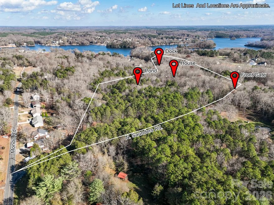 A rare opportunity awaits to own this gated 26-acre estate, seven springs on Lake Norman, complete with a private boat dock. The property showcases exceptional features, including a 2-acre spring-fed pond, a spacious 1,678 sq. ft. detached garage/workshop adaptable for multiple uses, former horse stalls, and a charming potting shed or she-shed. Ideally situated just outside the Long Island Airport strip, this remarkable estate offers endless possibilities and areas to explore. Additional amenities include state-of-the-art surround sound, a whole-home generator, an electric vehicle charging station in the garage, fruit trees, a full home theater in the basement with a 3D projector, and solid mahogany doors throughout. The outdoor living area is truly extraordinary, featuring a resort-style saltwater pool with waterfall and spa, a built-in grill, an outdoor fireplace, and a projector with screen. Multiple tiers of outdoor entertaining spaces create an unmatched setting for gatherings and relaxation. Inside, the great room is highlighted by an exquisite mirror imported from England, adding a sophisticated and timeless touch. The home boasts multiple fireplaces, rich Brazilian hardwood floors, dual grand staircases, and elegant marble flooring. The gourmet chef’s kitchen features double ovens, a gas cooktop, and sweeping views of the property from nearly every room. This exceptional estate is truly one-of-a-kind—an unparalleled offering that must be experienced in person to be fully appreciated.