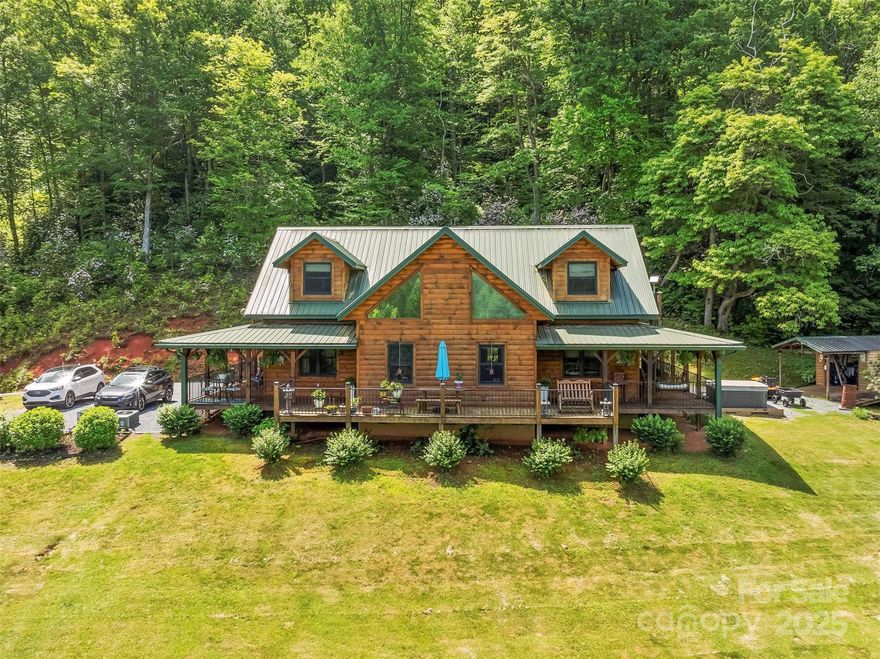 Are you searching for a mountain log home? Check out this beauty!  Outside you'll find wrap around porches over looking your mountain views.  Plenty of sunlight and open area for playing or gardening. You'll also enjoy the hot tub, fire pit and shed. Inside on the main floor presents with an open floor plan with a large kitchen, dining room and living room. The living room has a wonderful stone fireplace to enjoy on chilly nights. Main level primary bedroom with ensuite makes for easy living with an additional bedroom on main.  Upstairs is a bedroom, a bonus/bedroom, a generous loft and a bathroom. Plenty of space for family and friends. No need to climb up a mountain to get here! Convenient to Bryson City, Sylva and Cherokee.